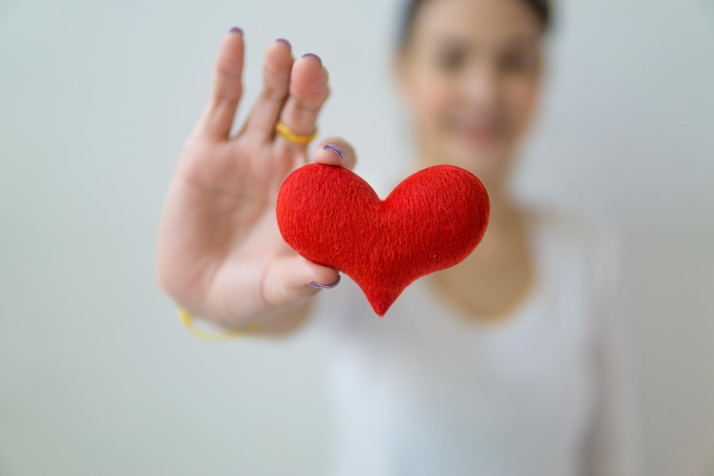 Woman. Red Heart. Close up. 